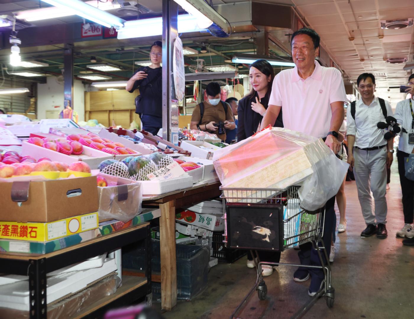 鴻海創辦人郭台銘參訪濱江果菜市場，開心購買蔬果。中央社