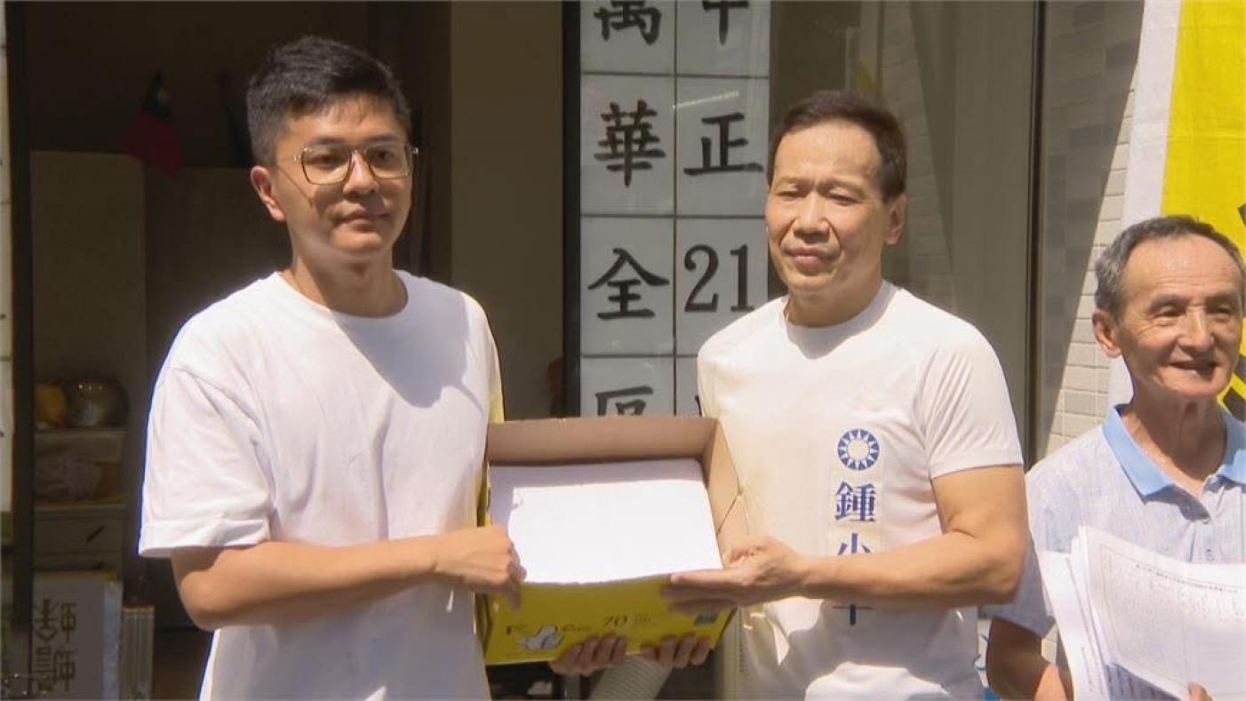 鍾小平拿一箱罷免吳沛憶連署書給李孝亮。翻攝網路